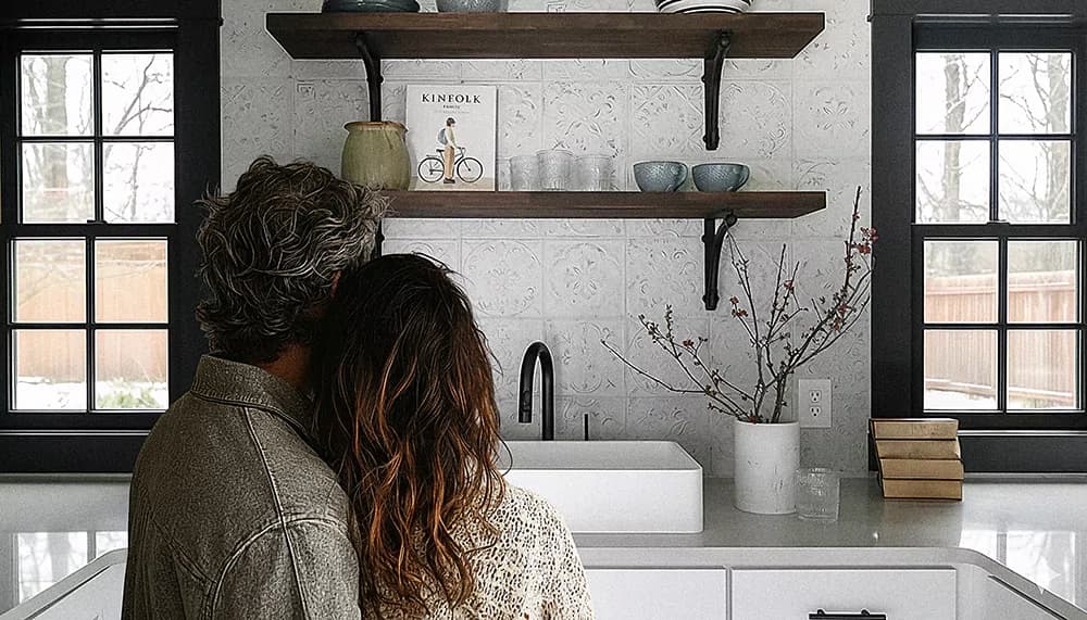 Homeowner admiring a newly installed kitchen tile backsplash in Central Florida home