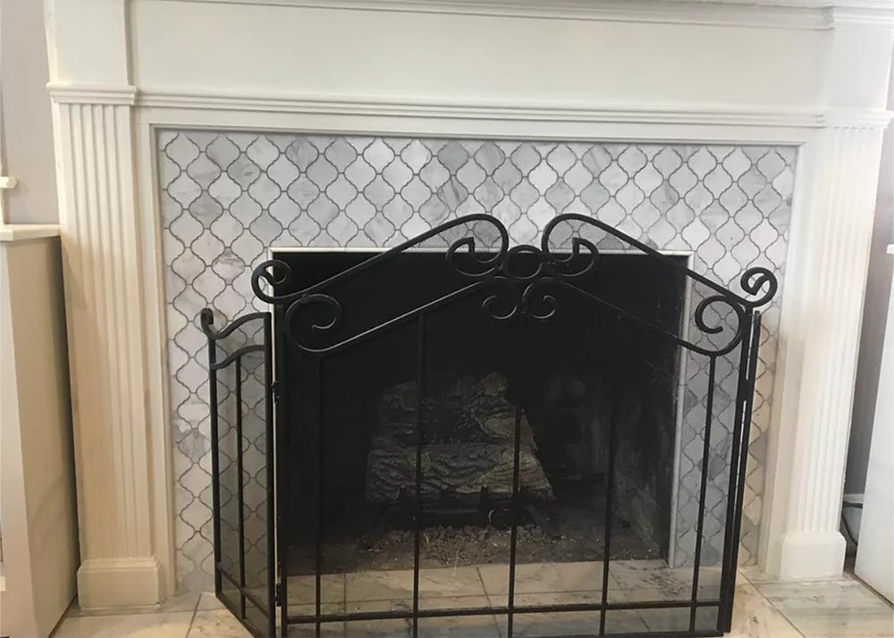 Custom porcelain fireplace surround tile installation in Groveland, FL living room by Aesthetic Tile