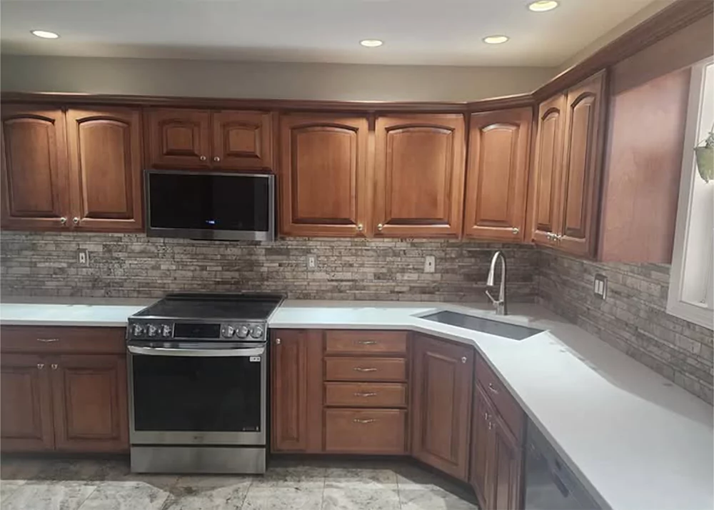 Multitone stone wedge kitchen backsplash installation in Minneola, FL by Aesthetic Tile