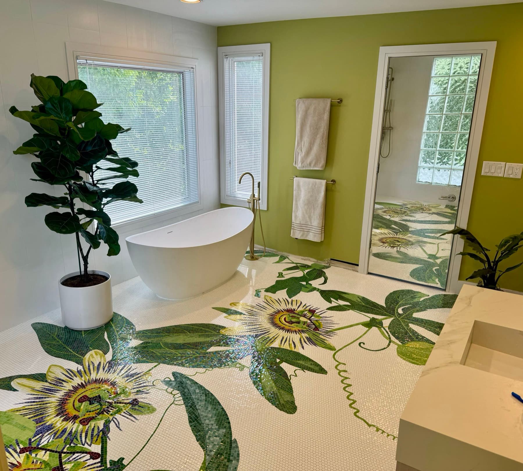 Completed botanical mosaic bathroom floor installation by Aesthetic Tile