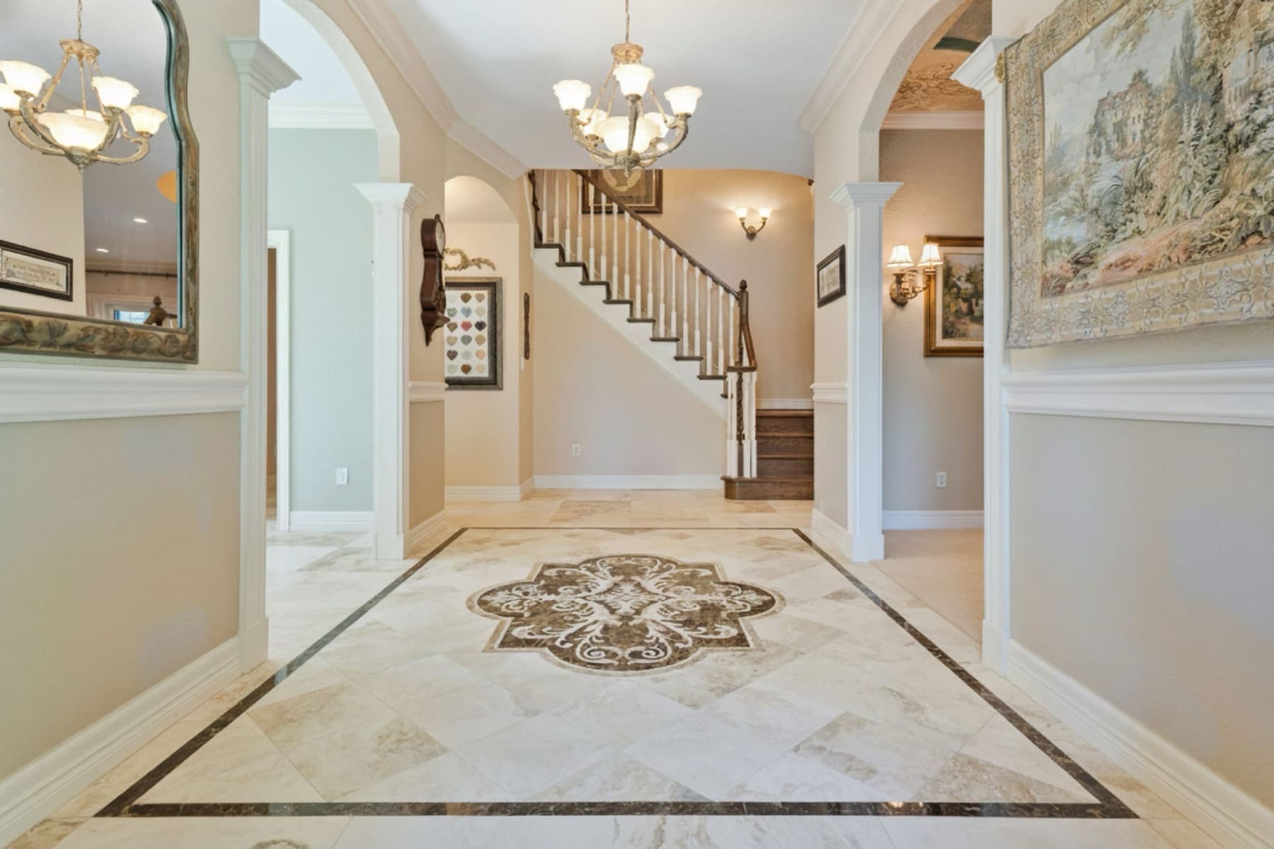 Custom stone foyer medallion and tile floor installed by Aesthetic Tile