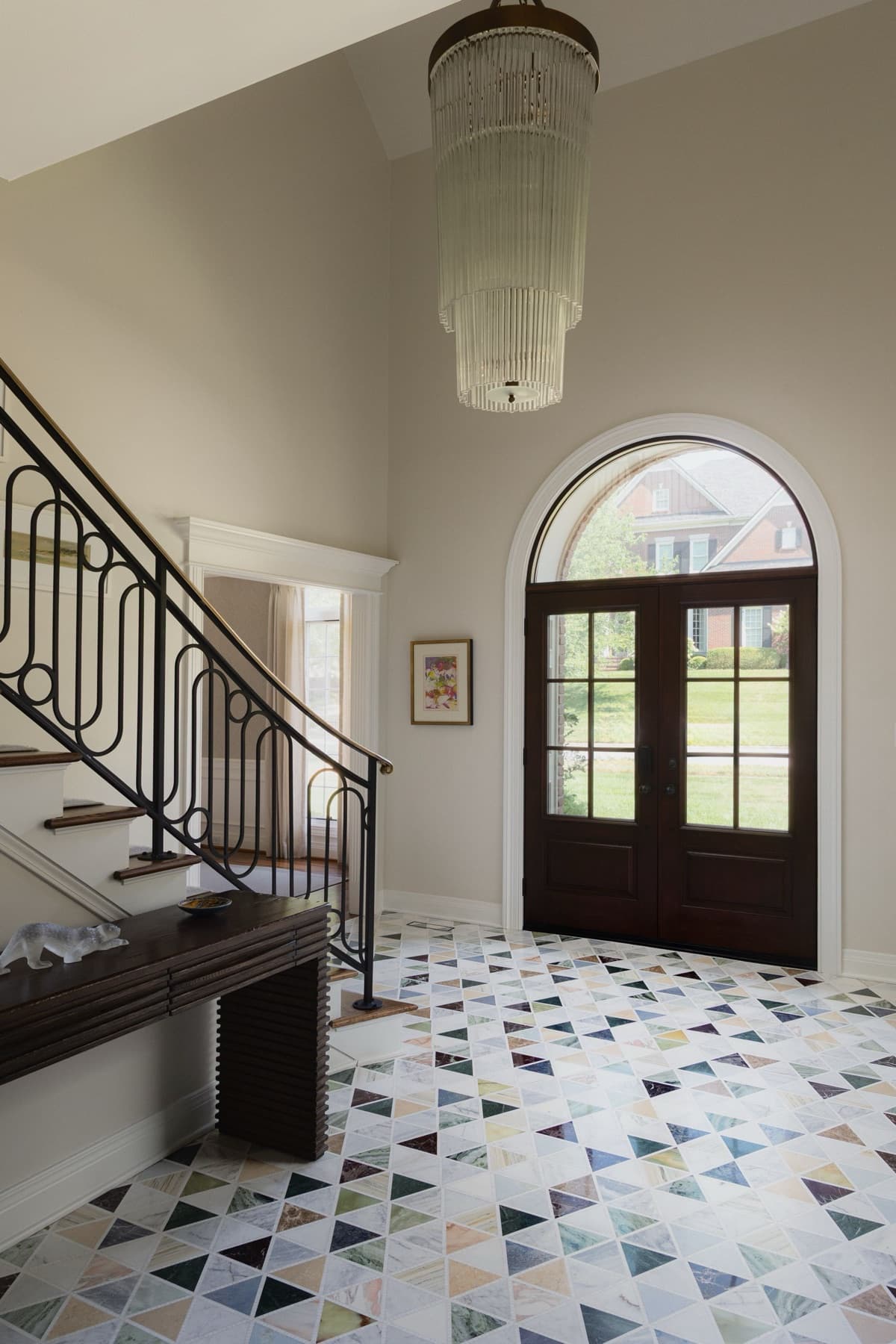 Geometric multicolor stone entry floor installed by Aesthetic Tile